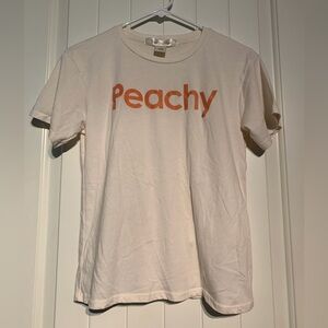 #144 Women’s Juniors EUC Youth in Revolt Peachy Cream T-Shirt size Medium